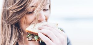 Woman eating sandwich